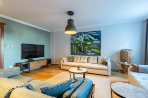 a living room with a couch and a tv at Delightful Flat with Bosphorus View in Kuzguncuk in Istanbul