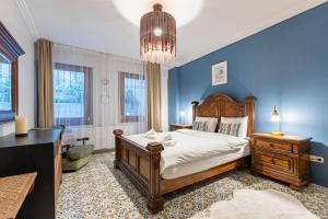 a bedroom with a large bed and a blue wall at Delightful Flat with Bosphorus View in Kuzguncuk in Istanbul