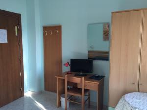 a room with a desk with a computer on it at Hotel Corallo in Finale Ligure