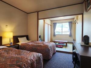 Postel nebo postele na pokoji v ubytování Hotel Meribel Tsugaike