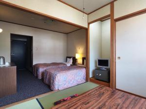 Postel nebo postele na pokoji v ubytování Hotel Meribel Tsugaike
