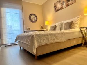 a bedroom with a large bed and a window at Sopot House in Sopot