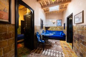 a room with a blue couch and a table at Kasbah Dar Daif in Ouarzazate
