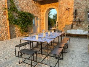 a long table and chairs in a building at I Carusi Relais in Noto