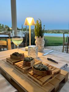 a table with some bread and a glass of wine at I Carusi Relais in Noto