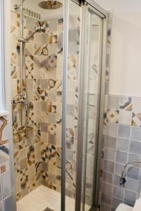a shower with a glass door in a bathroom at Tuent in Port de Pollensa
