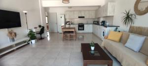 a living room with a couch and a table at Oasis Nature in Polis Chrysochous