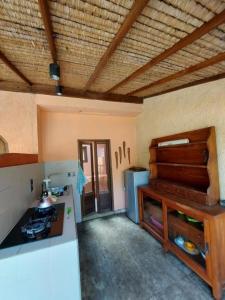 a kitchen with a stove and a counter top at Santan Gili Cottages in Gili Trawangan