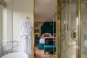 a bathroom with a shower and a bedroom at Hotel d’Inghilterra Roma – Starhotels Collezione in Rome