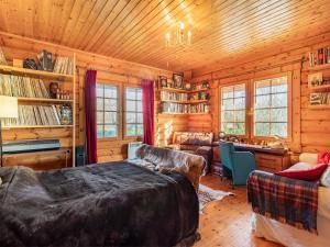 a log cabin bedroom with a bed and a desk at Grebe Lodge lodge 6 in Stratton Strawless