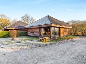 a log cabin with a porch on a driveway at Grebe Lodge lodge 6 in Stratton Strawless