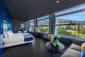 a bedroom with a bed and a large window at Lido Palace - The Leading Hotels of the World in Riva del Garda +37 photos
