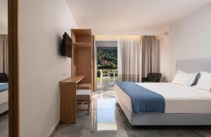a hotel room with a bed and a balcony at Notia Luxury Living in Porto Koufo