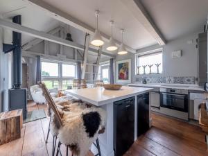 a kitchen with a large island with a counter top at Green Farm Barn in Wrenbury