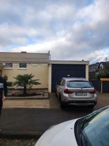 a car parked in a parking lot in front of a house at Olgas Ferienwohnung Saarburg Bahnhofstraße 13G in Saarburg