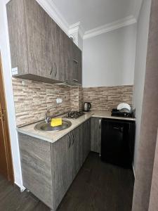 a kitchen with a sink and a counter top at Villa Bakuriani in Bakuriani