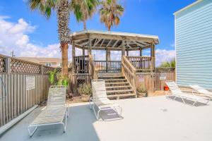a deck with chairs and a gazebo at Lyla's Beach Getaway in Padre Island