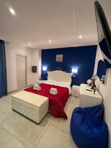 a bedroom with a large bed with a red blanket at Samcri Luxury Home in Catania