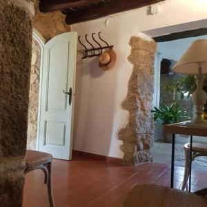 a room with a door and a table and chairs at Masia Can Pitu in Santa Cristina d'Aro