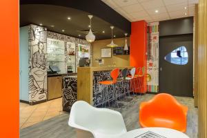a restaurant with orange chairs and a bar at ibis Hotel Erfurt Altstadt in Erfurt