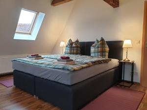 a bedroom with a large bed with two pillows at Ferienhaus Oberlausitz in Cunewalde