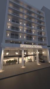 a man standing in front of a large building at International Atene hotel in Athens