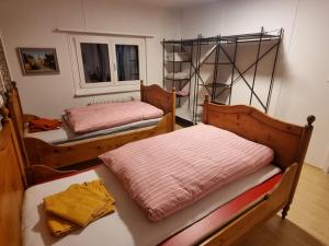 a room with two beds and a window at 24-7 Rooms in Sennwald