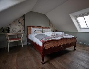 a bedroom with a large bed in a attic at Monkstadt 1745 Luxury Lodge in Portree