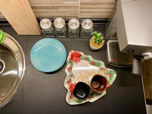 a kitchen counter with two cups and plates and a sink at Apartman Ninkovic in Pale