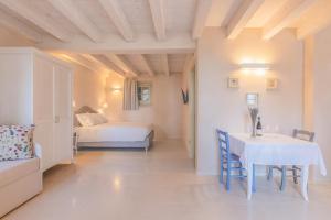 a room with a table and a bed and a bedroom at Palazzo Montanari Art & Wine Luxury Apartments in Fumane