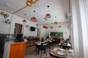 a restaurant with tables and chairs in a room at Mountain View Hotel in La Digue