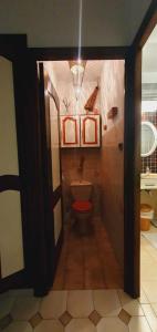 a bathroom with a toilet with a red seat at Bed and breakfast chez l'habitant in Marseille