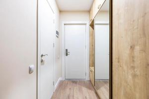 einen Flur mit Spiegel und Tür in der Unterkunft New Gudauri, Alpic - Ski Resort at Your Doorstep - Stylish & Comfy Ski Apartment with ski-depot and Stunning Mountain Views in Gudauri + 22 Fotos