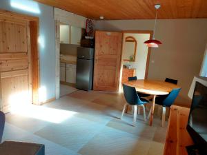 a kitchen and dining room with a table and chairs at Les Hauts de Brochot in Saint-Maurice-sur-Moselle