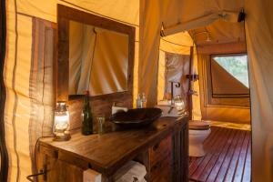 a bathroom with a sink and a toilet in a tent at Baobab Tented Camp in Kwa Kuchinia