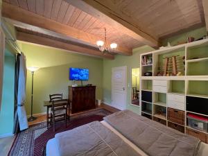 a bedroom with a bed and a table and a tv at Ute's Fachwerk in Wolthausen