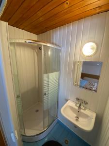 a white bathroom with a sink and a shower at Casa Aramis in Azuga +47 photos