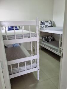 a couple of bunk beds in a room at Mar Doce Lar in Guaratuba