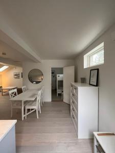 a kitchen and dining room with a table and chairs at Nice Apartment close to everything in Malmö