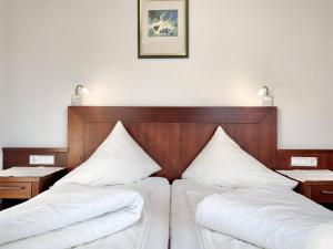 Postel nebo postele na pokoji v ubytování Hotel Garni Philipp