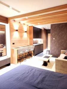 a room with a bed and a kitchen and a couch at Kopaonik Woodside in Kopaonik