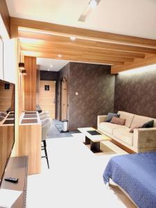 a living room with a bed and a couch at Kopaonik Woodside in Kopaonik