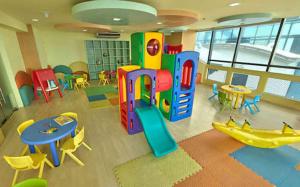 a room with a play area with tables and chairs at Comfy Bunkbeds at BSA in Manila