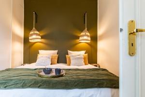 a bedroom with a bed with a tray on it at L' ALCOVE- Confort Charme Downtown in Dijon