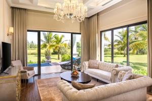 a living room with a couch and a table at Meliá Vinpearl Cua Sot Beach Resort in Ha Tinh