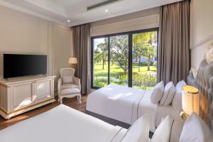 a hotel room with two beds and a large window at Vinpearl Cua Sot Resort, Affiliated by Melia in Ha Tinh +25 photos
