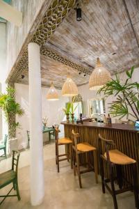 a bar in a restaurant with chairs and lights at Moi Galle Fort by DBI in Galle