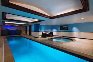 a swimming pool in a hotel with blue lighting at The Stephen F Austin Royal Sonesta Hotel in Austin