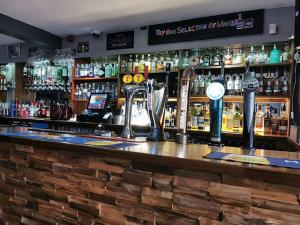 a bar with a lot of bottles of alcohol at Islay Frigate Hotel in Tarbert