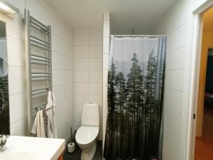 a bathroom with a shower curtain with trees on it at Nice house near the center of Ängelholm in Ängelholm